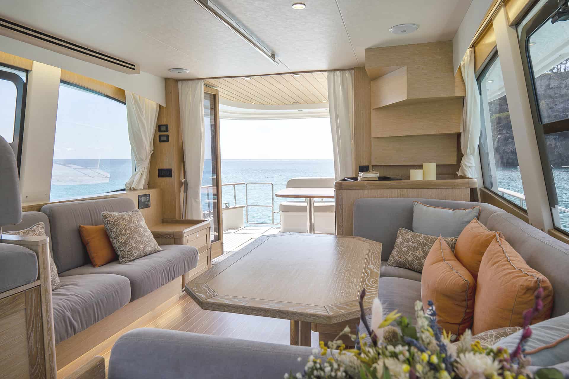 Salón interior de un Sasga Menorquín con sofás, mesa y vistas al mar